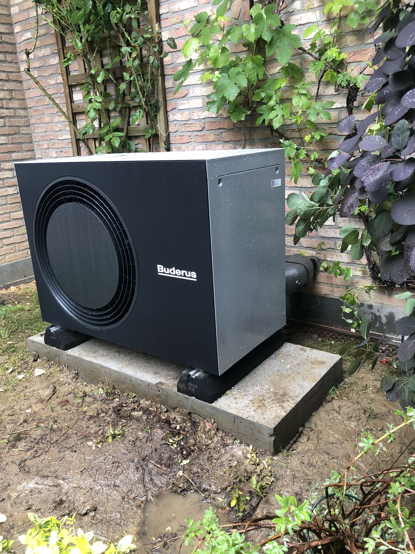 Buderus WLW176i heat pump installed in the garden by Ecowatt